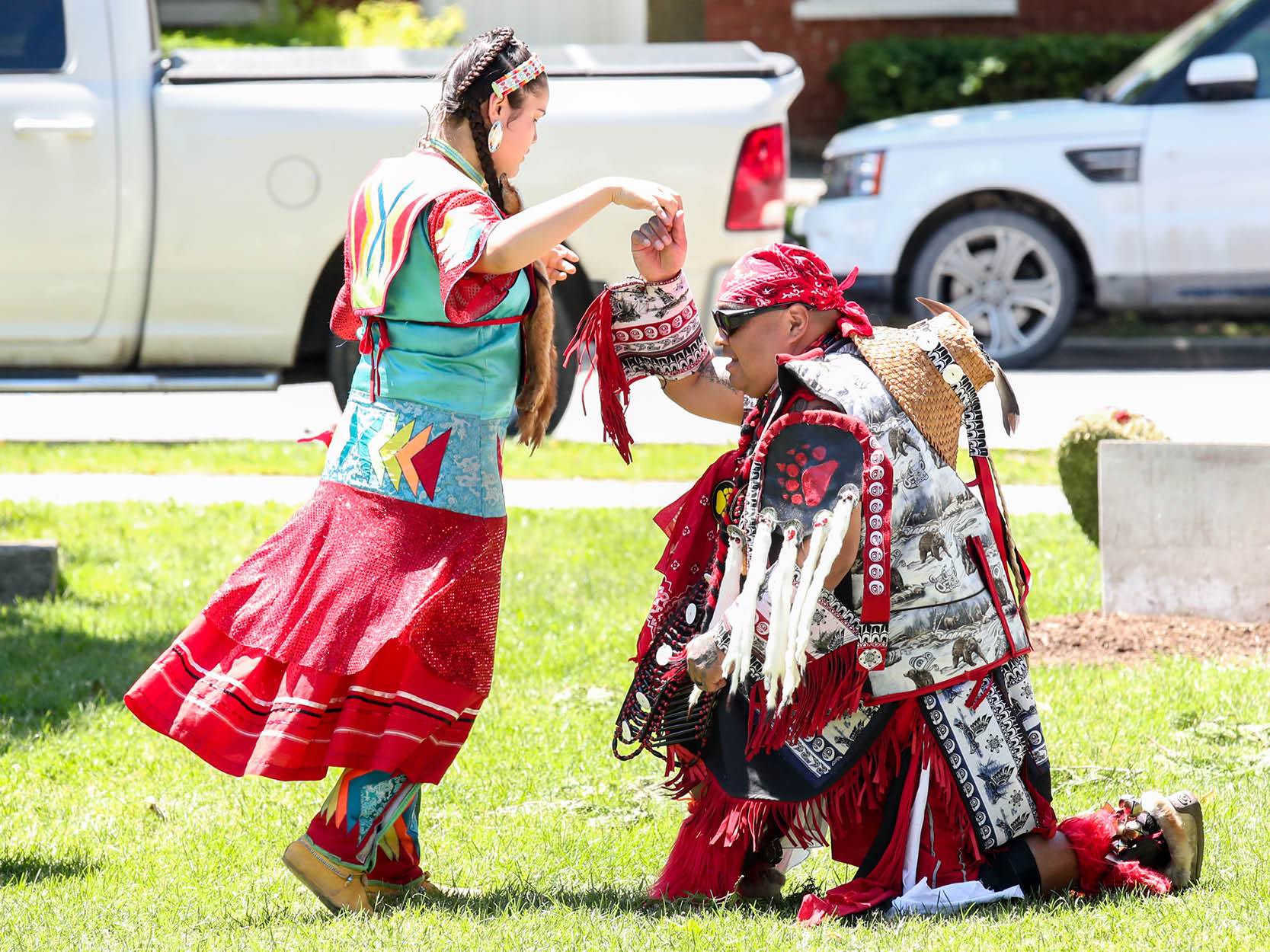 Two indigenous people dancing
